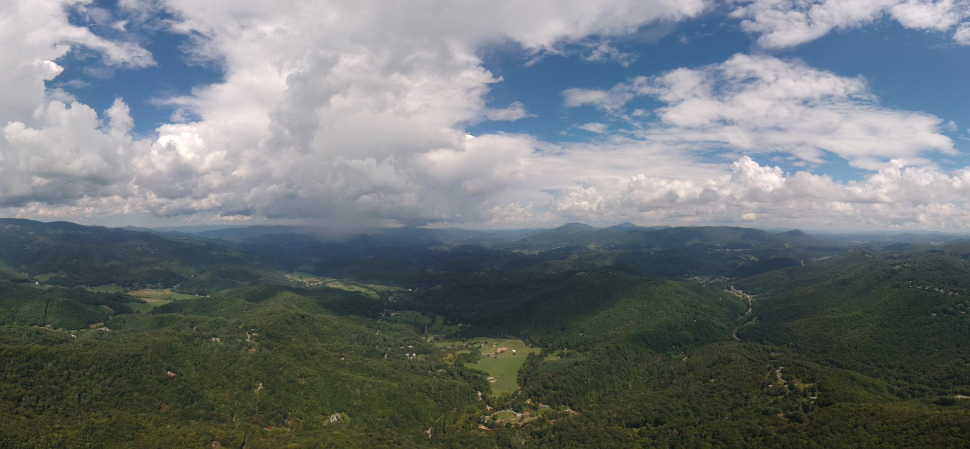 Aerial view of NC High Country valleys showing dense summer foliage