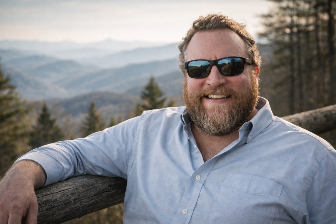 Andrew Plyler smiling with Blue Ridge mountains in the background