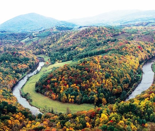 A new construction mountain home contrasted with a classic existing cabin in the NC High Country near Boone